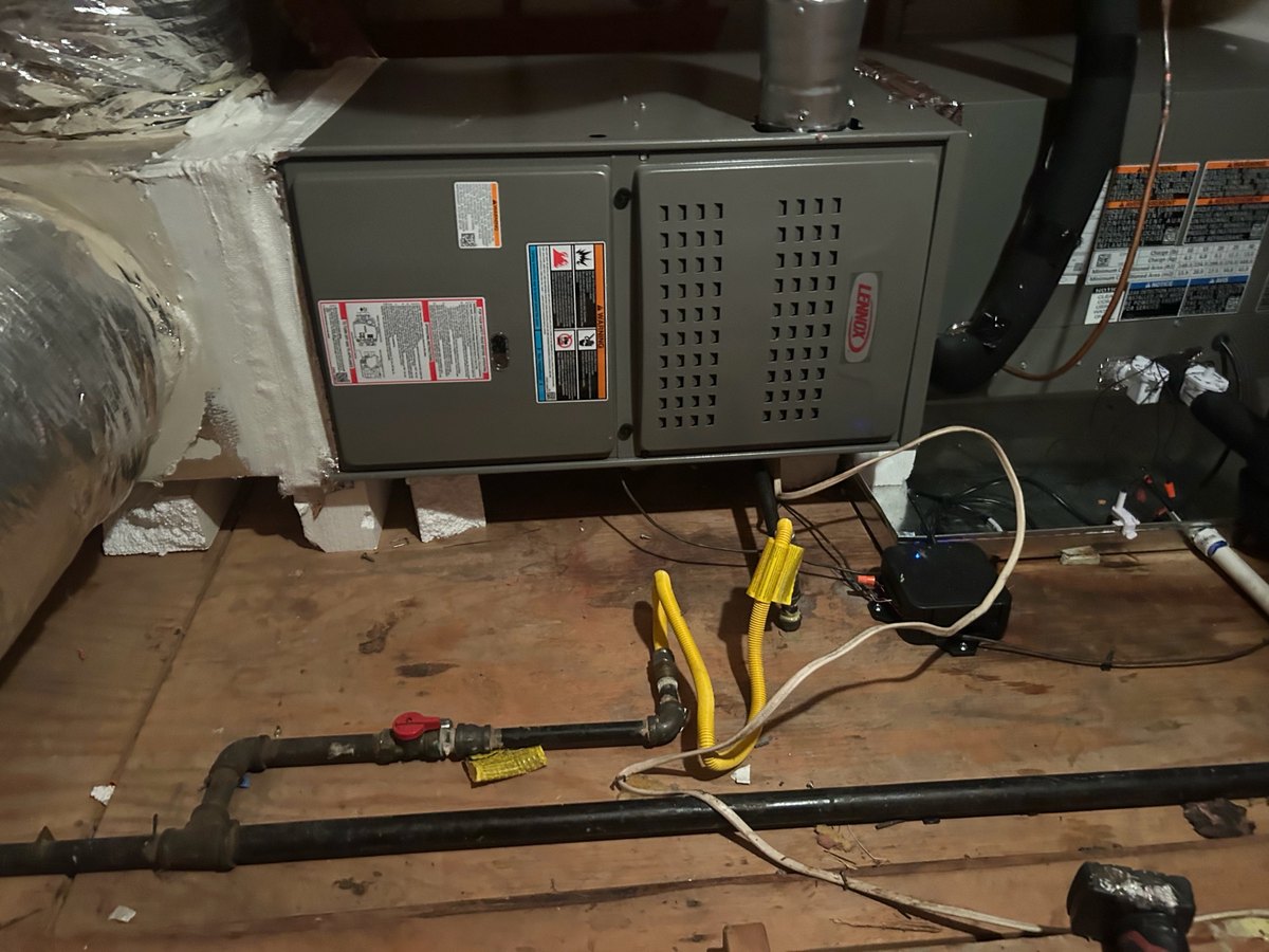 New Lennox furnace and evaporator coil installed together in an Austin attic, with flue, gas line and condensate pump