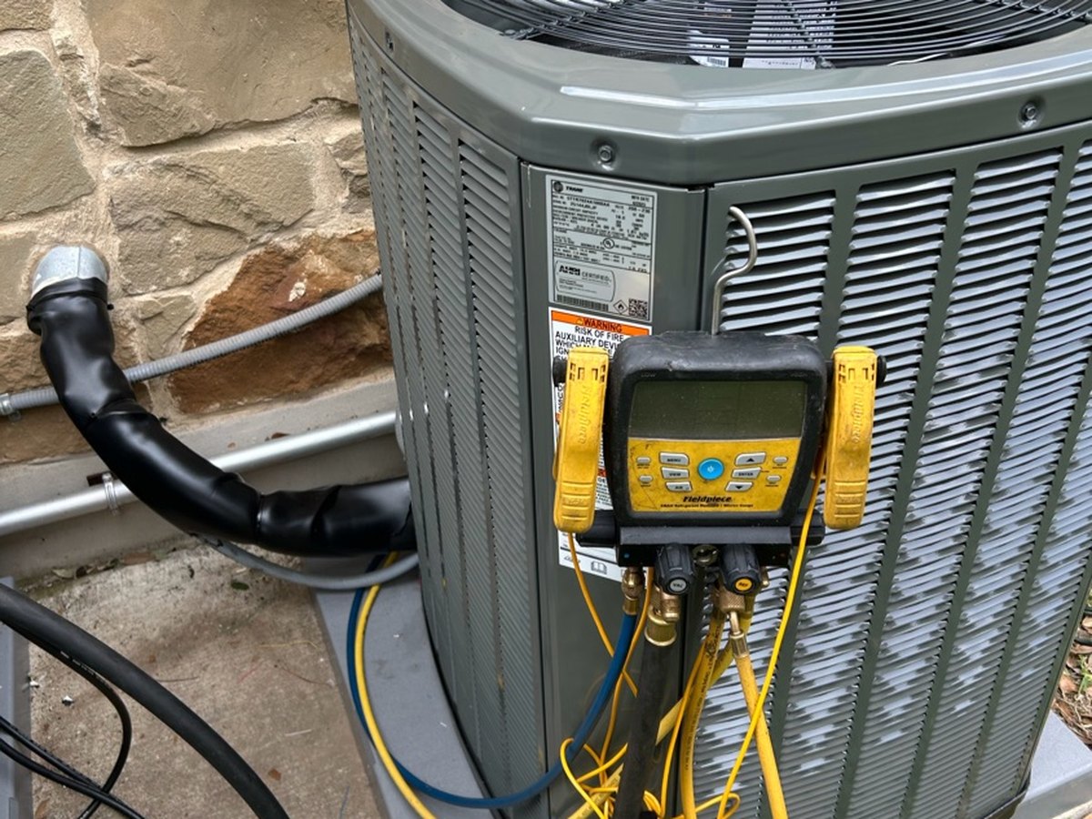 Hook EM technician commissioning a new system with a digital manifold
